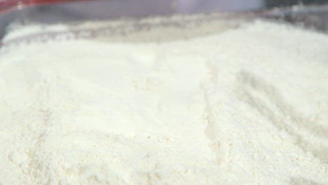 Coating meat with flour and dipping in egg mixture