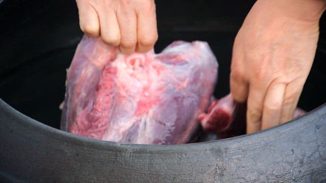 Raw meat placed in a cauldron filled with water
