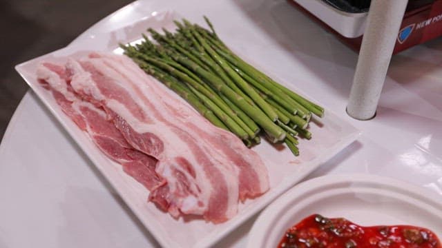 Fresh Thin-sliced Pork Belly and Asparagus on a Table