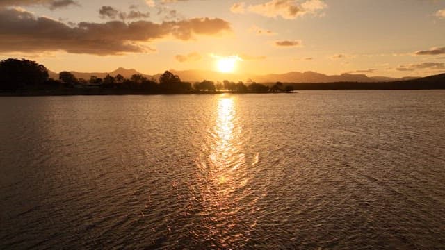 Sunset Over Tranquil Lake with Mountains