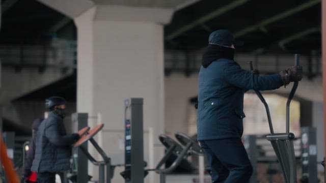 People exercising under a bridge