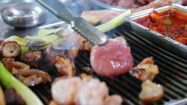 Grilled pork parts, golden brown on a grill at a meat restaurant
