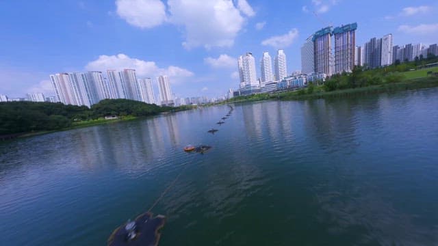 Lake with City Skyline on Sunny Day