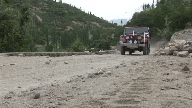 Jeep Traveling on a Remote Mountain Road