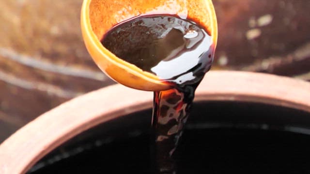 Pouring traditional brown fermented soy sauce
