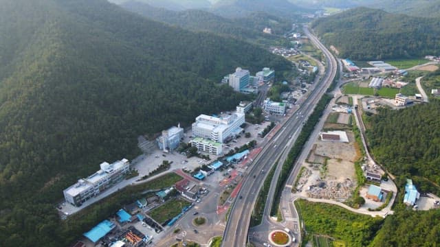 Scenic view of a town surrounded by mountains