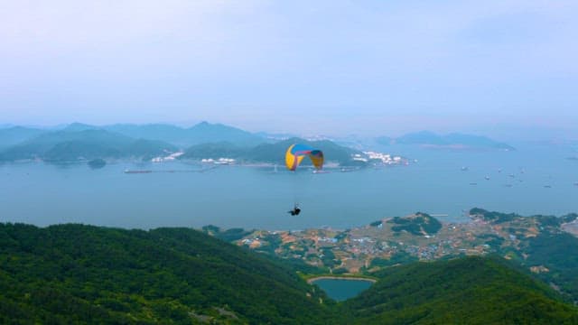 Paragliding Over Scenic Mountainous Landscape by the Sea