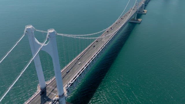 Gwangan Bridge with cars passing over the vast emerald sea