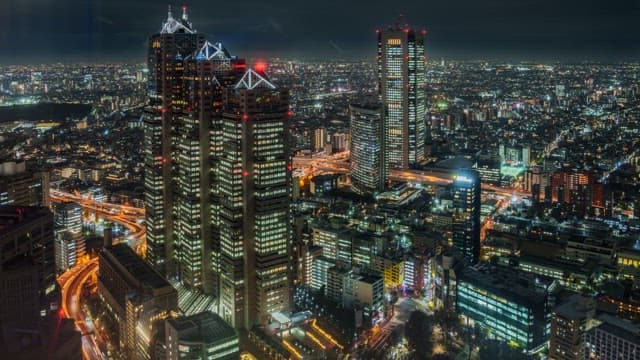 Bustling cityscape at night with skyscrapers