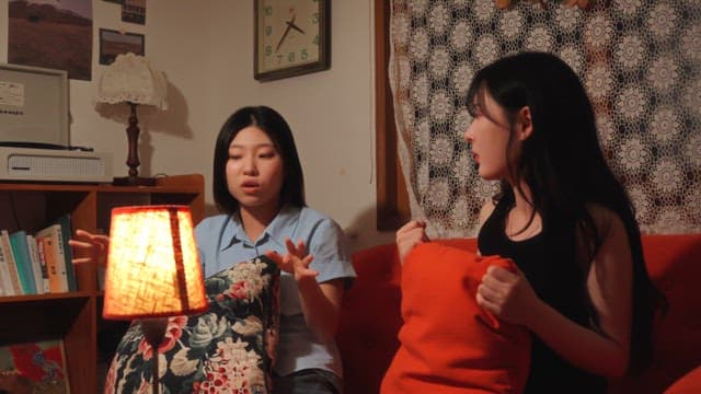 Two women having a conversation on a sofa