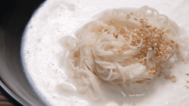 Bowl of Noodles in Cold Soybean Soup Topped with Sesame Seeds