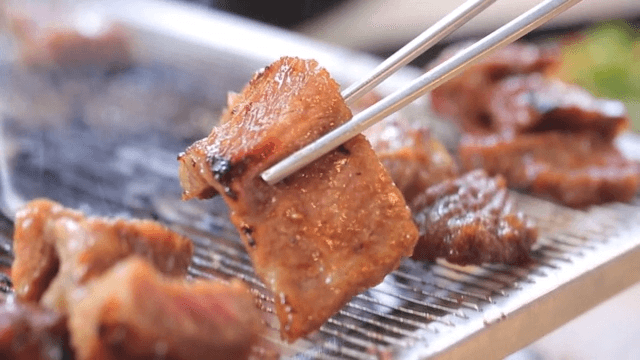 Grilled Pork Ribs Sizzling on a Grill