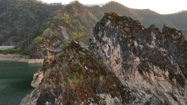 Scenic river with rocky cliffs and a bridge