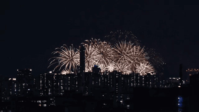 Fireworks over a city skyline at night