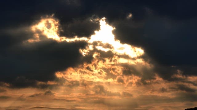 Sunlight breaking through dark clouds