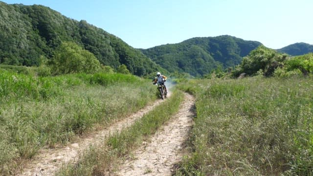 Motorcyclists Riding On A Rural Trail