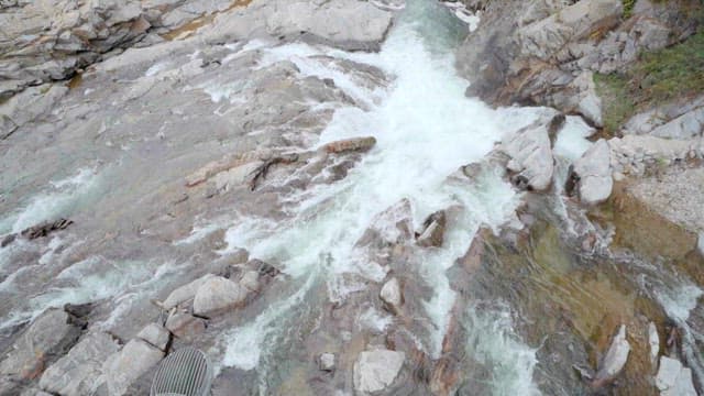 Stream Flowing through Rocks in a Mountain Valley
