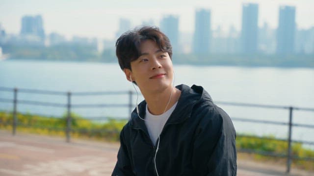 Man listening to music by the riverside