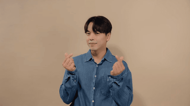 Man giving finger hearts with happy expression