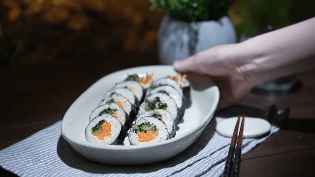 Serving delicious kimbap platter on a table