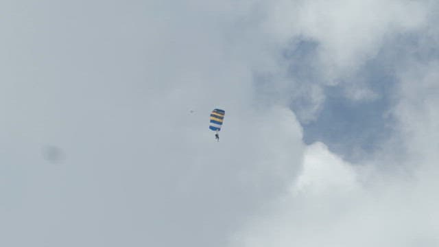 Skydiver descending with a parachute