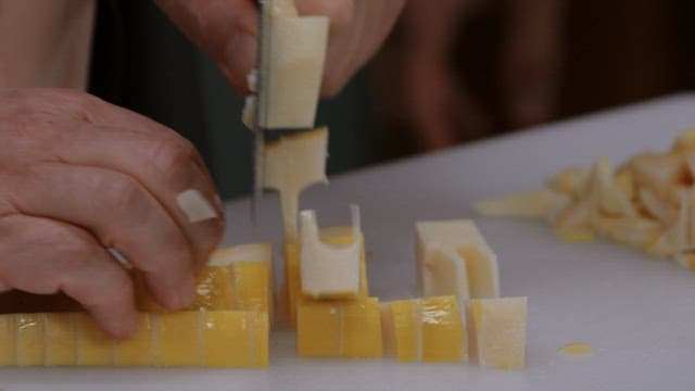 Cutting boiled bamboo shoots with a knife on a cutting board