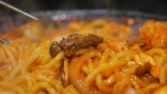 Udon noodles picked up with chopsticks