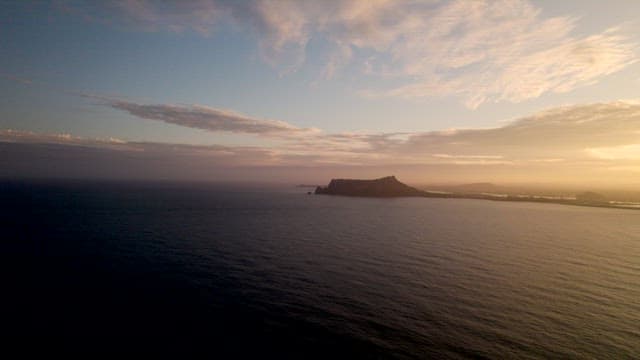 Twilight Sea and Calm Sky with Silhouette of Island