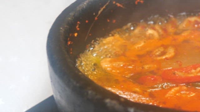 Boiling spicy seafood stew in a stone pot