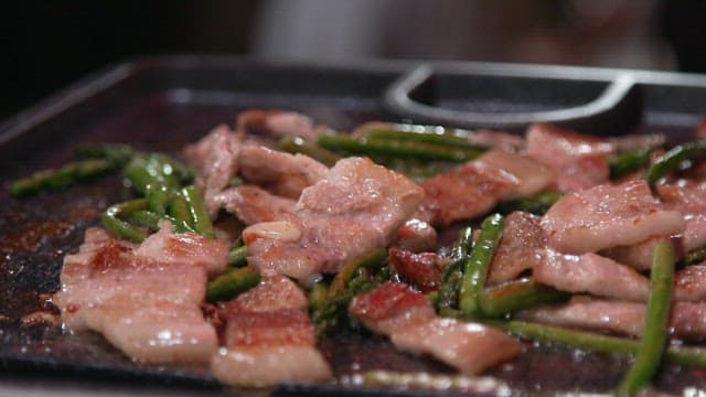 Dipping Grilled Thin-sliced Pork Belly and Asparagus in Sauce