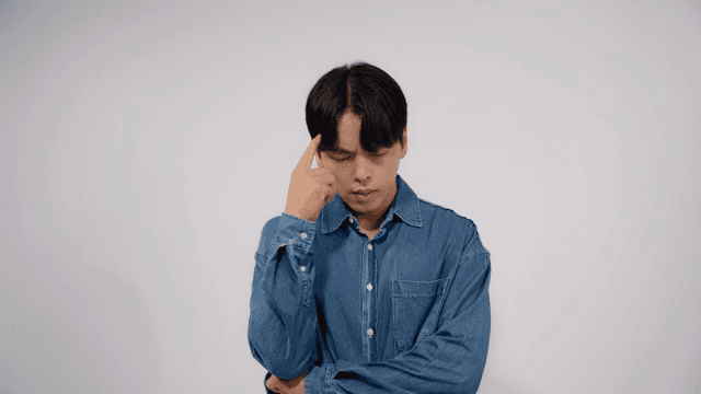 Man in agony and despair, holding his head with his hands