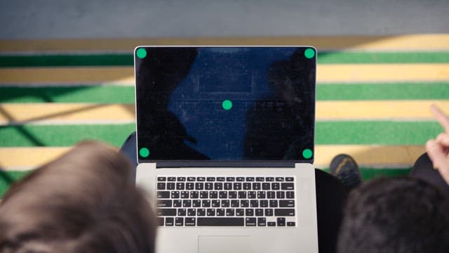 Two People Sharing a Laptop