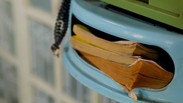 Old books on the payphone shelf