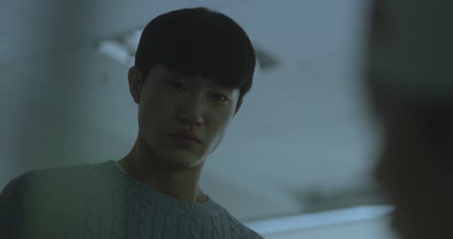 Man crying with a depressed expression in a dark room