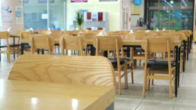 Empty restaurant with wooden chairs and tables