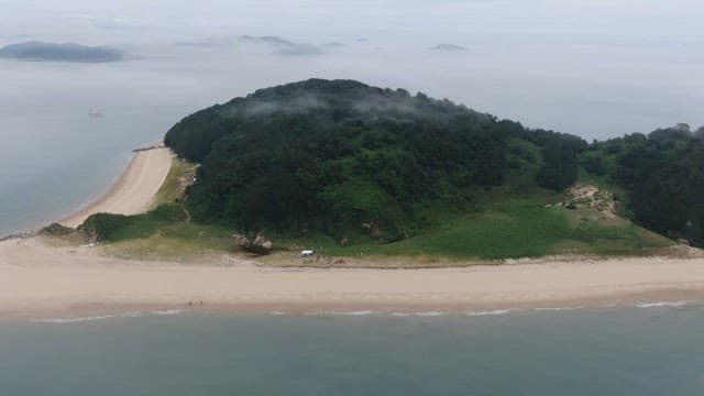 Serene Island with Fog and Beach