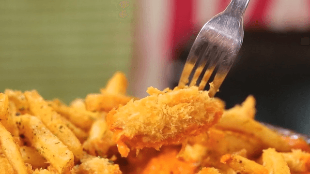 Crispy fried boneless chicken with a fork
