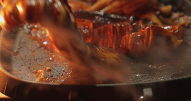 Sizzling squid being cooked on a grill