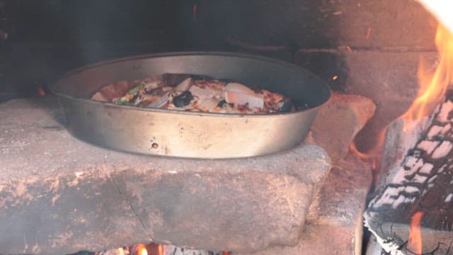 Pizza baking in a brick oven