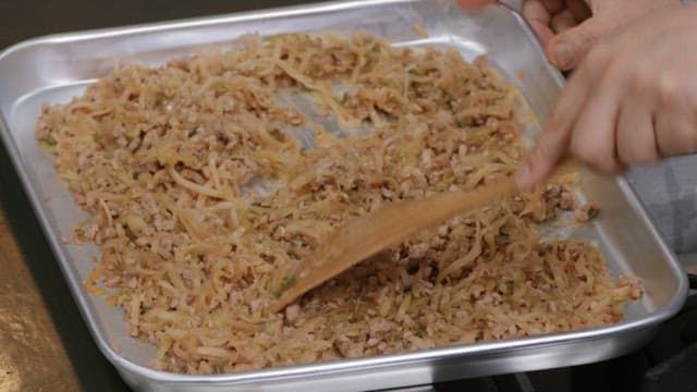 Mixing ingredients on a tray in a kitchen