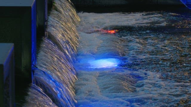 Stream illuminated by lights at night