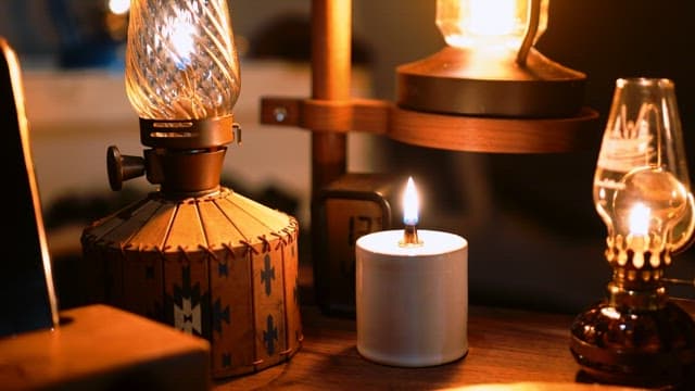 Cozy indoor setting with various decorative lamps and lit candles