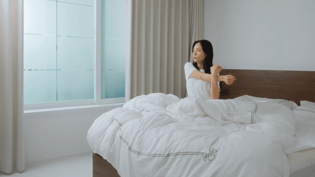 Woman waking up in the morning and stretching