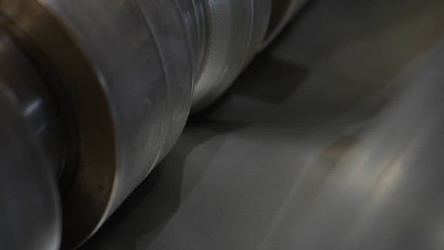 Close-up of metal rollers in operation