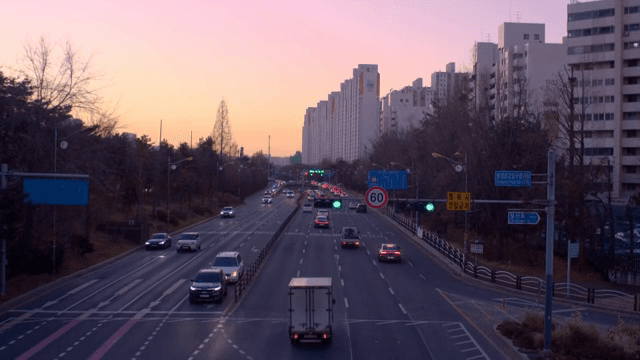 City road with cars during sunset