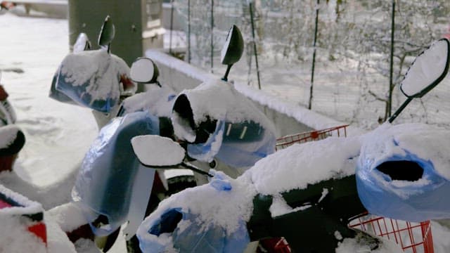 Motorcycles covered in white snow on a cold winter day