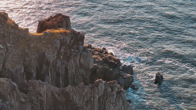 Rocky Coastline with Waves at Sunset 