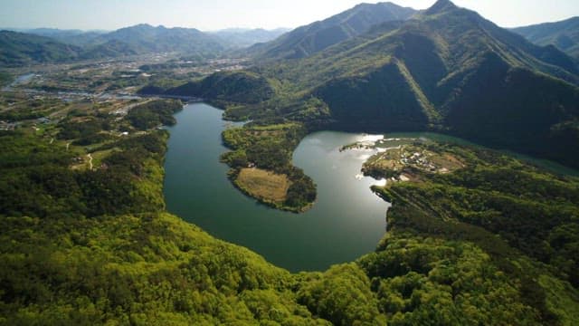 Serene river winding through lush green mountains