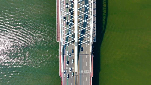 Cars driving on a bridge over river