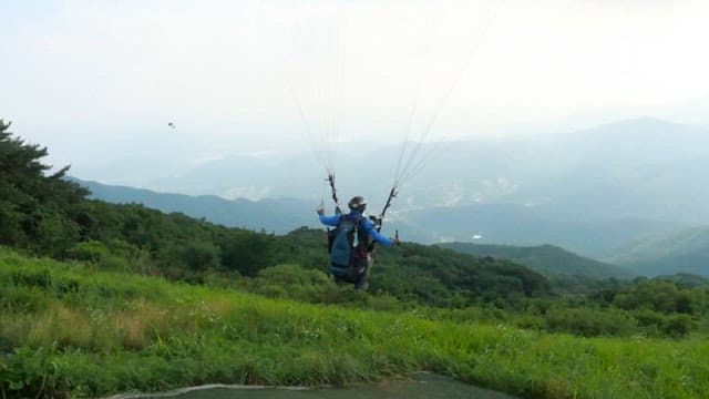 Paraglider flying over the scenic mountain landscape